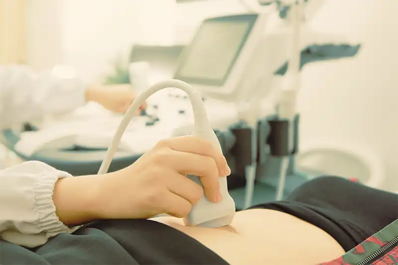 close up of ultrasound machine on female patient stomach