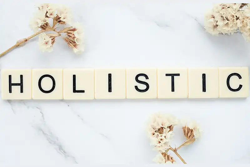 scrabble letters on table that spell holistic