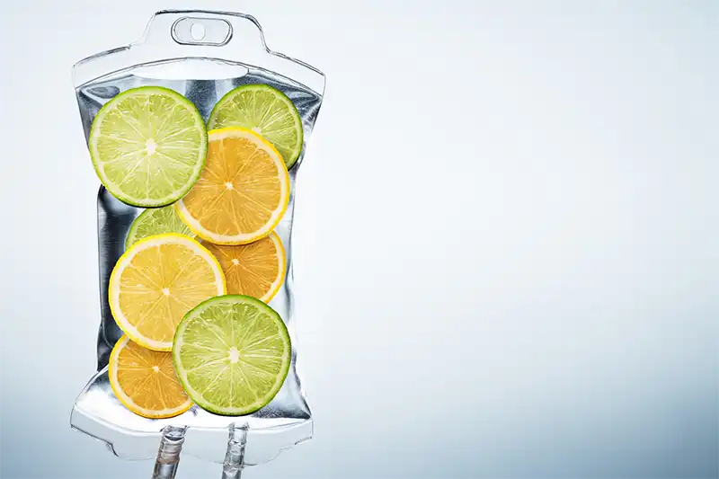 artistic version of IV vitamin therapy with infusion bag full of fruit